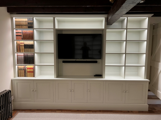 Painted bookcase on cupboards with lighting